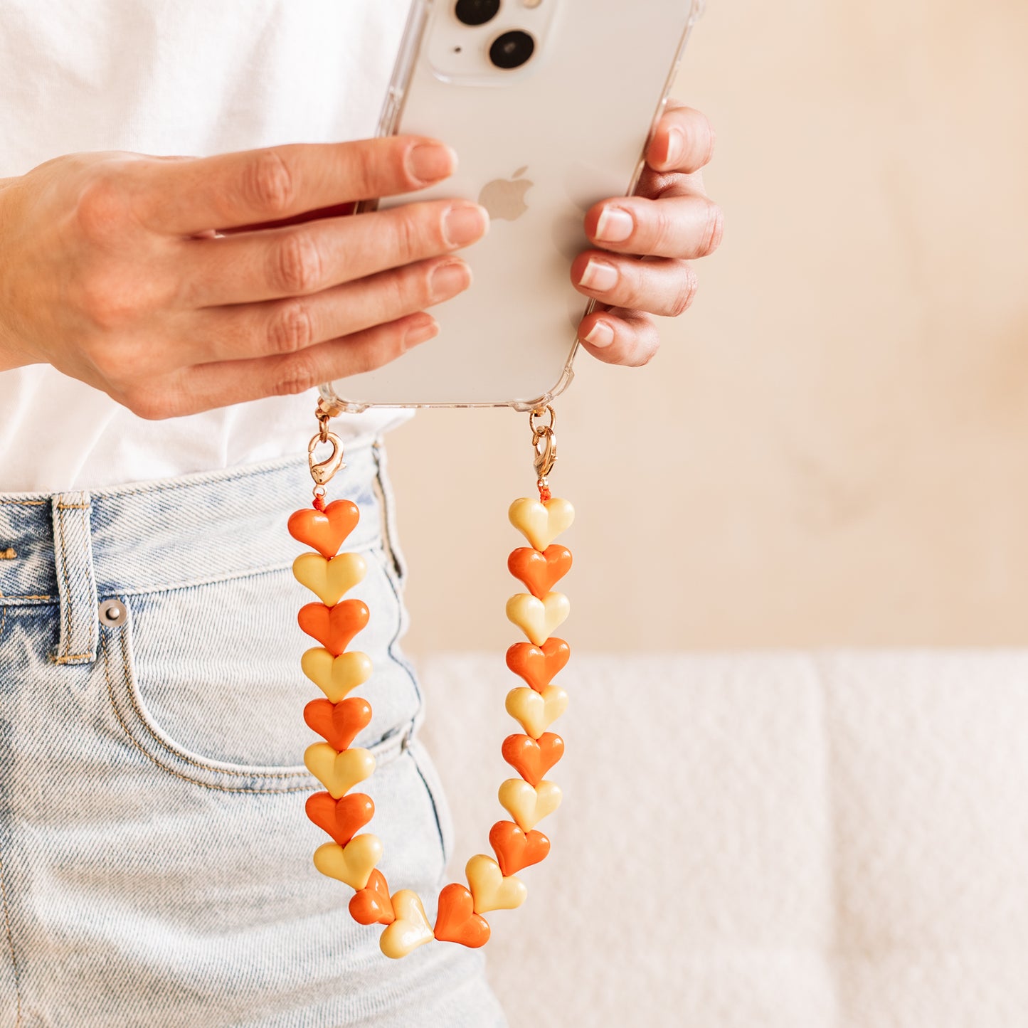 Phone case with orange & yellow hearts cord