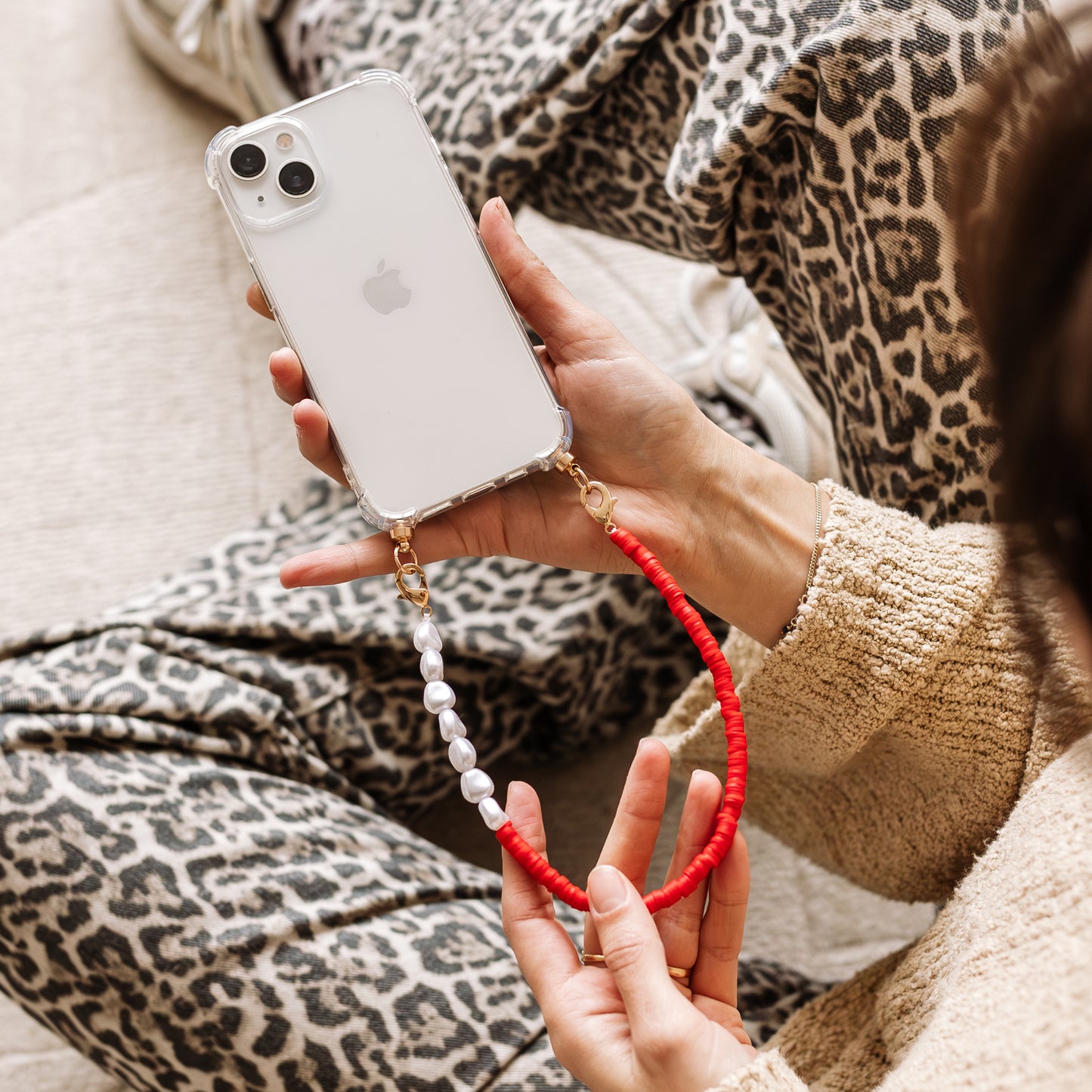 Phone case with red & pearl cord